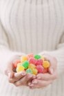 Hands holding jelly sweets — Stock Photo