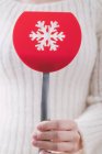 Woman holding festive spatula with snowflake shaped hole — Stock Photo
