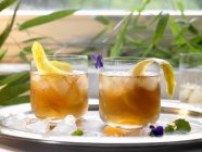 Iced tea with lemon peel in glasses — Stock Photo