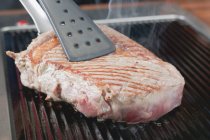 Grilling beef steak — Stock Photo