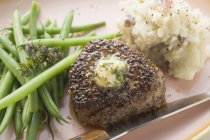 Peppered steak with herb butter — Stock Photo