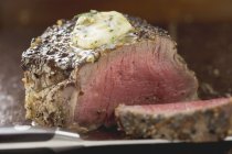 Peppered steak with herb butter — Stock Photo