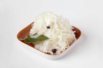 Sauerkraut in a small dish  on white surface — Stock Photo