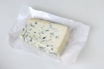 Blue cheese on paper — Stock Photo