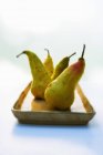 Four Organic Pears on Stoneware Dish — Stock Photo