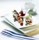 Closeup view of raspberry Cannelloni with a nut cream coating — Stock Photo