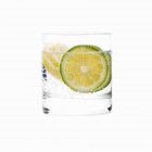 Glass of water with lime slices — Stock Photo