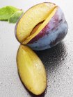 Fresh plum with drops of water — Stock Photo