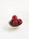 Small bowl of raspberries — Stock Photo
