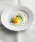 Plate with fried egg and chives — Stock Photo
