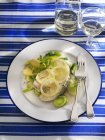 Cod with lemon and boiled potatoes — Stock Photo