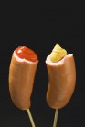 Sausages with ketchup and mustard — Stock Photo