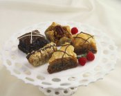 Closeup view of different Baklava pieces with raspberries on stand — Stock Photo