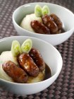 Closeup view of two bowls of Bangers sausages and mash — Stock Photo
