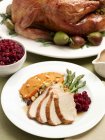 Closeup view of sliced turkey with cranberries, yams, asparagus and stuffing — Stock Photo