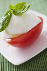 Tomatoes with mozzarella and basil — Stock Photo