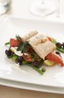 Salmon fillet on a bed of summer vegetables — Stock Photo
