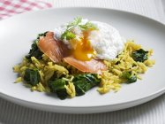 Poached egg with salmon on rice — Stock Photo