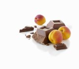 Apricots and pieces of chocolate — Stock Photo