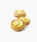 Closeup view of Crumpets with butter on white surface — Stock Photo