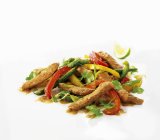 Fried sliced pork with pepper and cilantro — Stock Photo