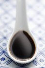 Soya sauce on a spoon — Stock Photo