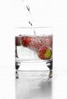 Water in glass with strawberries — Stock Photo