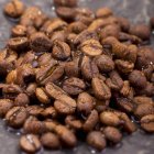 Coffee beans with drops of water — Stock Photo