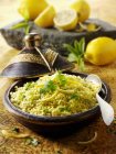 Couscous with lemons served in vintage wok — Stock Photo