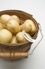 Organic potatoes in woodchip basket — Stock Photo