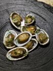 Abalone - sea snails with herb and onion sauce — Stock Photo