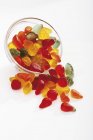 Closeup view of mixed gums falling out of glass bowl — Stock Photo