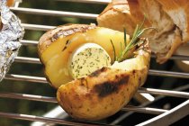 Barbecued potato with herb butter — Stock Photo