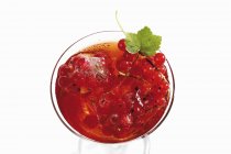 Juice with frozen redcurrants — Stock Photo
