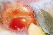 Peach in block of ice — Stock Photo
