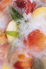 Peaches in block of ice — Stock Photo