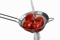 Washing tomatoes in sieve — Stock Photo