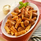 Rigatoni pasta with sauce and sausage — Stock Photo