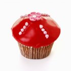 Muffin with red icing — Stock Photo