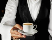 Waiter serving espresso in cup — Stock Photo