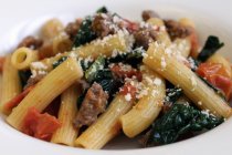Rigatoni pasta with spinach and sausage — Stock Photo