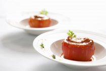 Baked stuffed tomatoes fresh abalone on white plates — Stock Photo