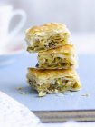Closeup view of stacked baklava pieces on blue surface — Stock Photo