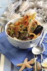 Closeup view of Cacciucco Italian fish soup with peas, prawns and shellfish — Stock Photo