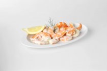 Shrimp salad with lemon wedge — Stock Photo