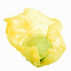 Meio limão com suco de limão salpicante — Fotografia de Stock