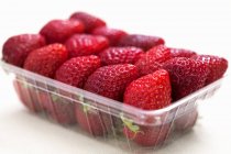 Strawberries in plastic punnet — Stock Photo