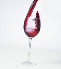 Pouring red wine into a glass — Stock Photo