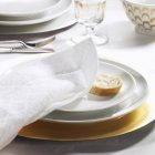 Festive place setting with fabric napkin and slice of baguette — Stock Photo