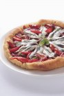 Anchovy tart with red peppers — Stock Photo